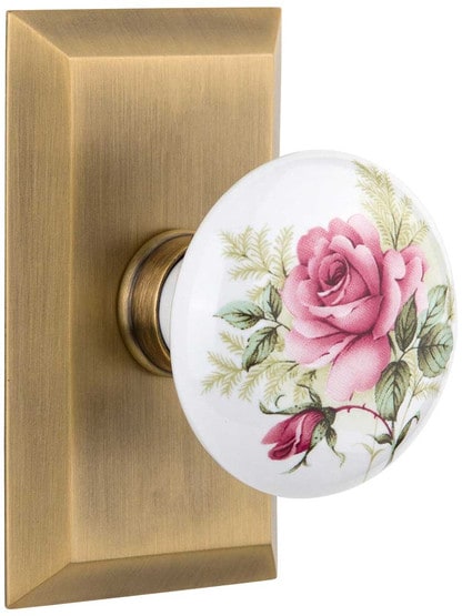 New York Rosette Door Set with Rose Porcelain Knobs in Antique Brass.
